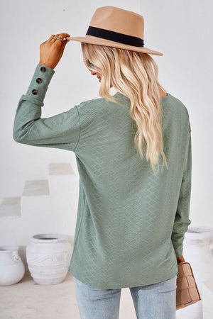 Sage green textured V-neck blouse with button cuff detail