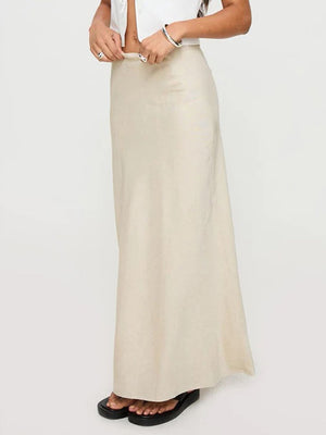 Beige bias-cut maxi skirt with a smooth finish and a flowing silhouette.