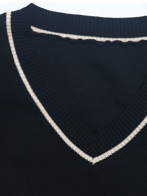 Black knit v-neck sweater with contrast trim and scalloped neckline detail