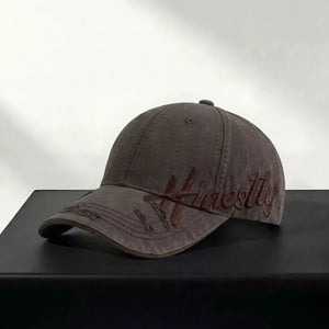 Brown cotton baseball cap with embroidered "Honestly" text and distressed details.