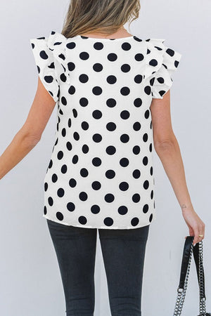 Polka dot blouse with flutter sleeves and V-neck.