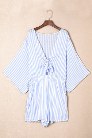 Light blue and white striped tie-front kimono jumpsuit with cinched waist and wide sleeves.