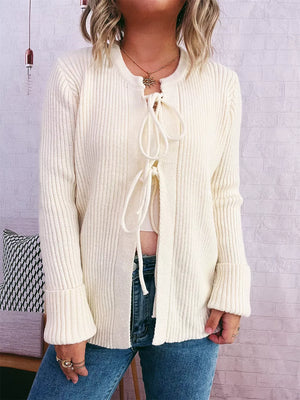 Ivory ribbed tie-front cardigan with cuffed sleeves and round neckline.