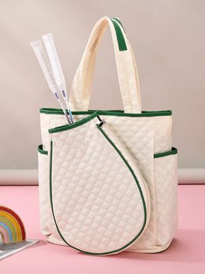 Quilted off-white sports racket backpack with green trim and two rackets.
