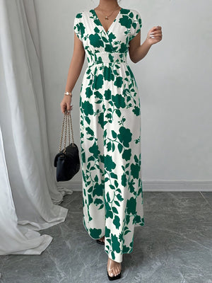 Floral surplice maxi dress with cap sleeves and smocked waist in white with green floral print.