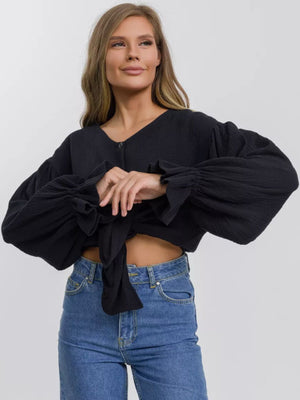 Black textured puff sleeve blouse with tie front and ruffled cuffs