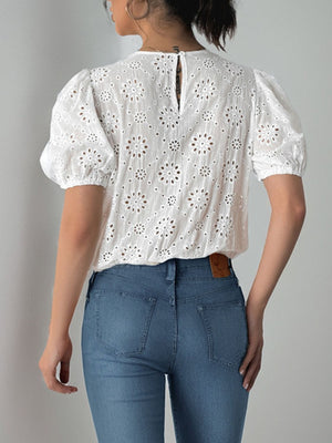 White eyelet bodysuit with puff sleeves and floral pattern, back view.