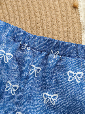 Blue cotton cami and shorts set with white bow print and elastic waistband.