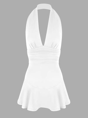 White halter dress with plunging V-neck, ruched waist, and ruffle hem