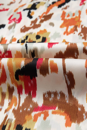 Blouse with abstract print in sherbet colors, featuring ruffled aura sleeves.