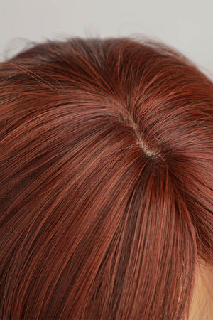 Layered copper red synthetic wig showing scalp detail