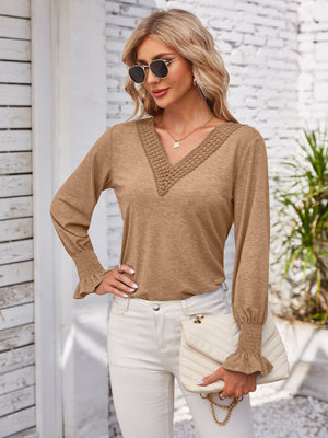 Camel blouson sleeve top with lace trim V-neck and smocked cuffs.