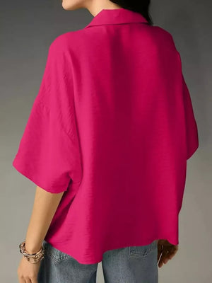 Hot pink half sleeve shirt with a collared neckline and relaxed fit.
