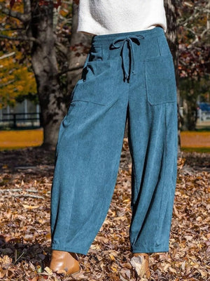 Blue corduroy wide-leg pants with pockets and drawstring waist.