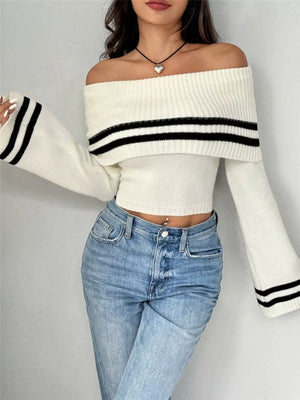 White off-shoulder cropped knit sweater with black stripe flare sleeves and ribbed detail.