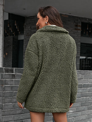 Green asymmetrical teddy moto jacket with a collared neckline and plush texture.