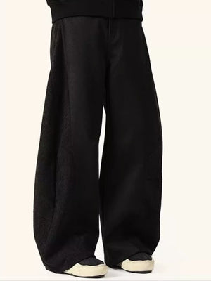 Black relaxed fit sweatpants with contrast textured panels.