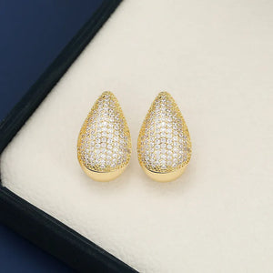 Pave teardrop stud earrings with gold base and clear stones.