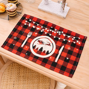 Red and black plaid placemat with Christmas lights, Santa, and snowflakes.