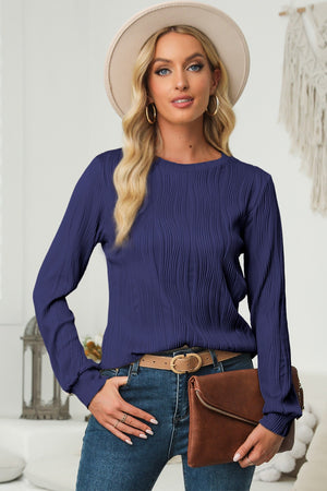 Navy crewneck pullover with textured wave pattern and long sleeves.