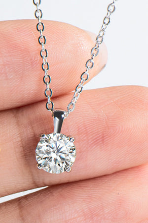 Silver solitaire pendant necklace with a round-cut diamond on a delicate chain.