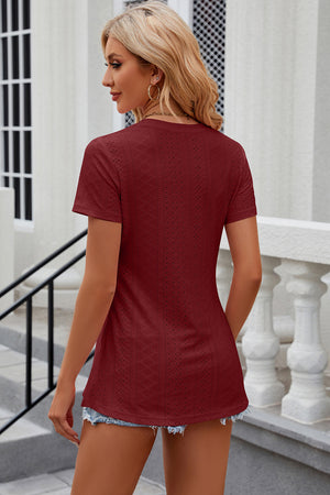 Burgundy crewneck top with allover perforation detail and short sleeves.