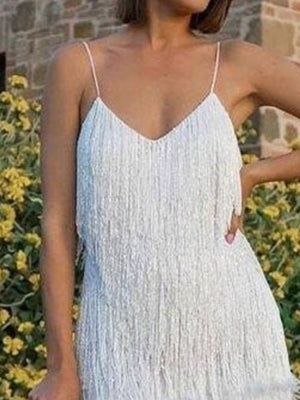 White fringe mini dress with spaghetti straps and V-neckline.