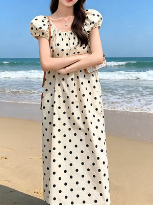 Cream polka dot midi dress with puff sleeves and square neckline.