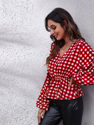 Red and white gingham peplum blouse with gathered waist and balloon sleeves.