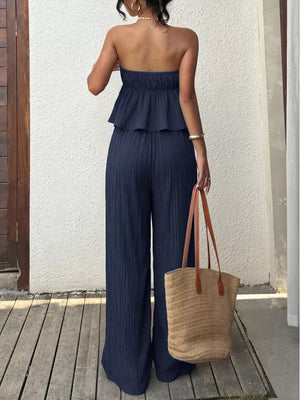 Navy ruffled peplum tube top and wide-leg pants set with textured fabric.