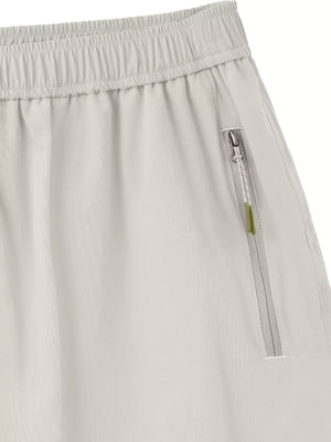 Light gray men's bermuda shorts with elastic waistband and zippered pocket detail.