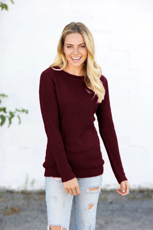 Burgundy honeycomb knit pullover sweater with crew neck and long sleeves.