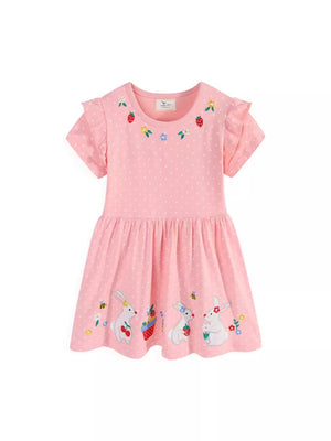 Pink polka dot cotton dress with embroidered bunnies, strawberries, and flowers. Ruffled sleeves.