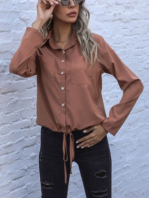 Caramel drawstring waist utility shirt with button front and chest pockets.