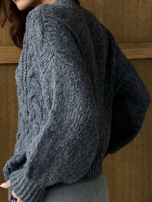 Gray cable-knit button-down cardigan with textured knit and ribbed cuffs.