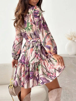 Delicate floral tie-waist mini dress with ruffled hem and button-down front.