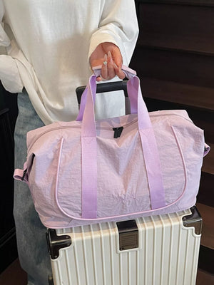 Purple lightweight Oxford cloth duffel bag with embroidered detail and purple straps.