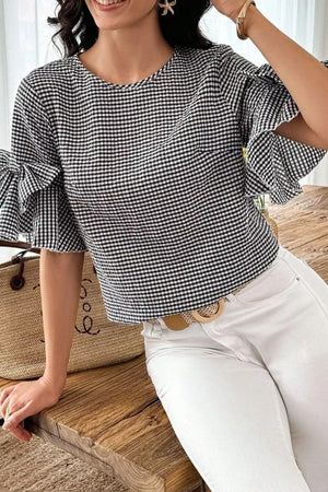 Black and white gingham polyester shirt with ruffled bow tie sleeves and a crew neck.
