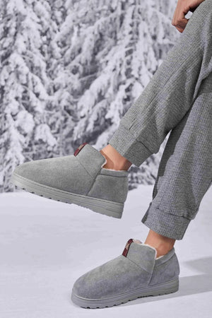 Gray suede shearling-lined house booties with burgundy tab detail.