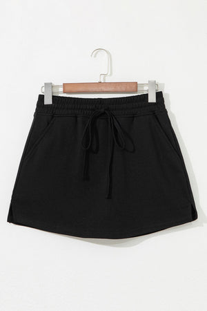 Black French terry drawstring skort with pockets and elastic waistband.