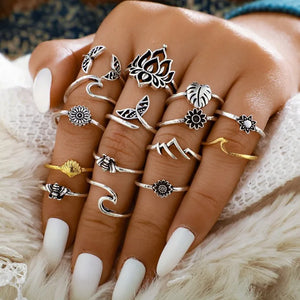 Botanical & Sculptural Ring Stack in silver alloy with lotus, flower, bee, wave, and mountain designs.