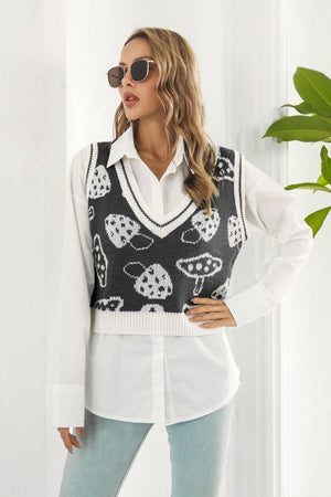 Black knit vest with white mushroom motif, V-neck, ribbed trim, cropped length.