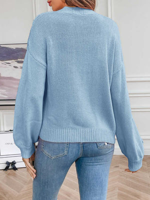 Light Blue acrylic knit cardigan with balloon sleeves and embroidered detail on the cuff.