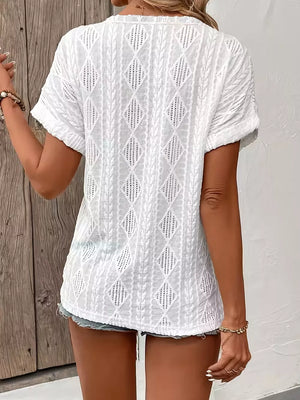 White short-sleeve t-shirt with a diamond pattern and textured fabric.
