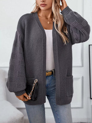 Chunky knit open-front cardigan in dark gray with pockets and textured sleeves.