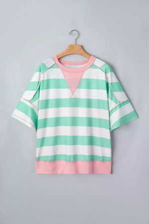 Oversized t-shirt with green and white stripes, pink neckline and hem, and exposed seams.
