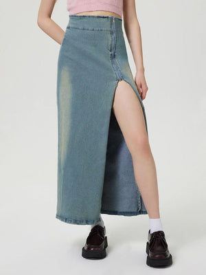 Denim maxi skirt in medium wash with front slit and zipper detail.