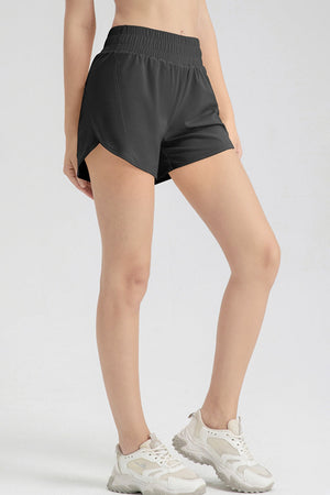 Black layered performance running shorts with elastic waistband and side slits