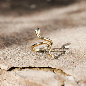 Gold finish serpentine coil ring with a bypass design and textured band.