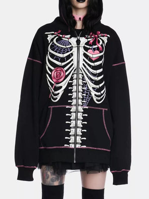 Black zip-up hoodie with playful skeleton graphic, pink stitching, and drawstring hood.